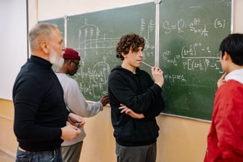 Finding patterns is what maths is all about - image of group of people thinking about a problem